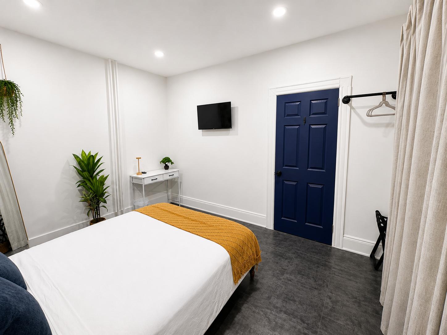Second view of Havrenza Room Four with television and storage